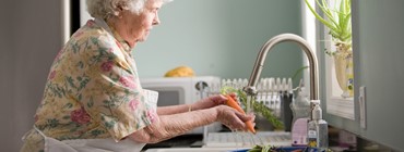 older woman cooking at home